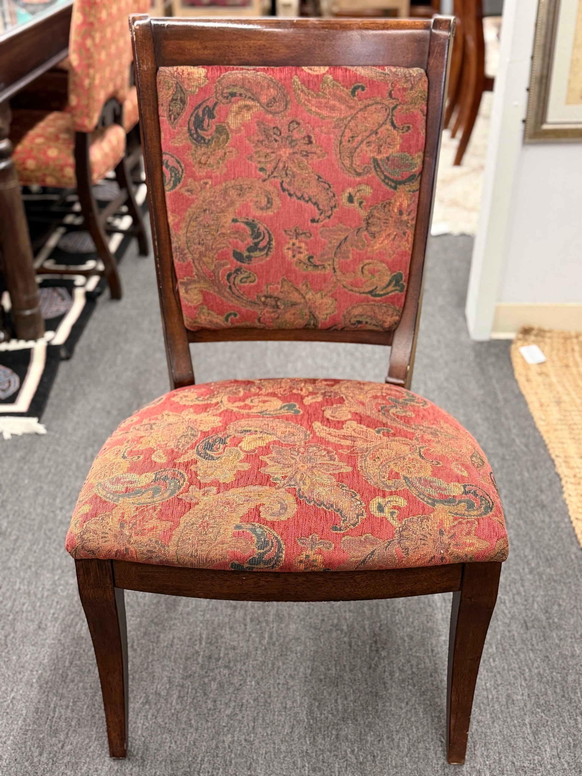 Wooden chair with paisley patterned fabric in a room setting