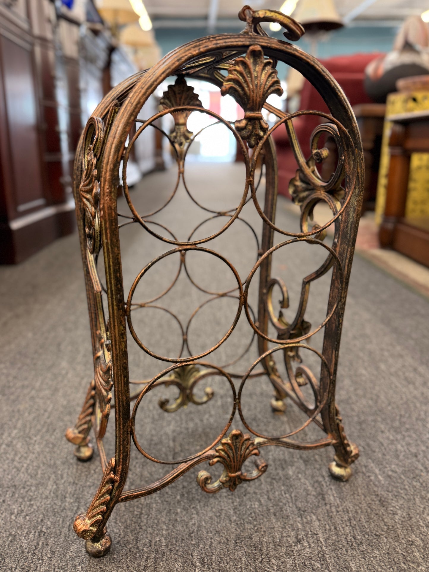 Decorative metal wine rack on a carpeted floor