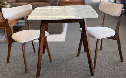 Dining table with four chairs in a room setting