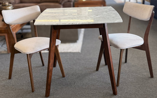 Dining table with four chairs in a room setting