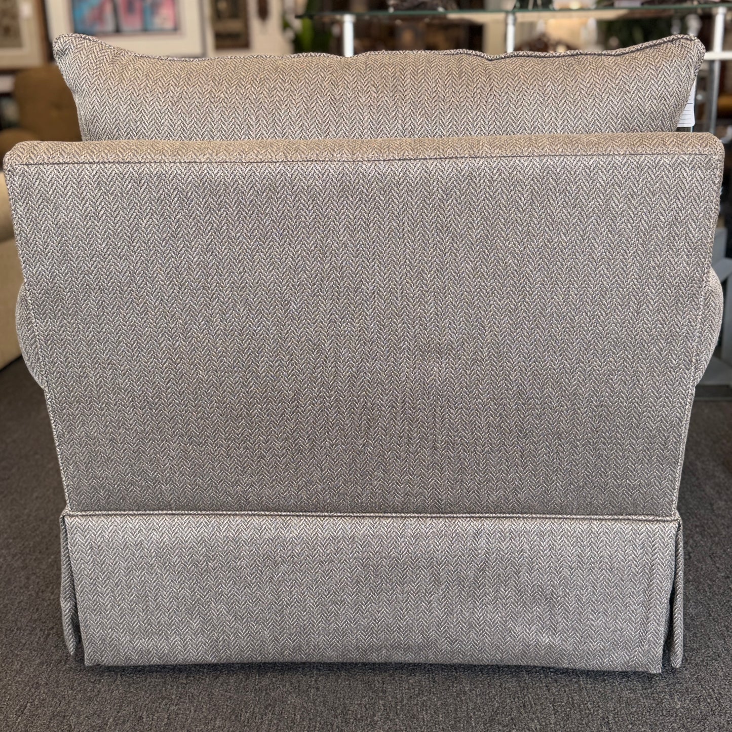 Gray upholstered headboard on a bed in a bedroom setting