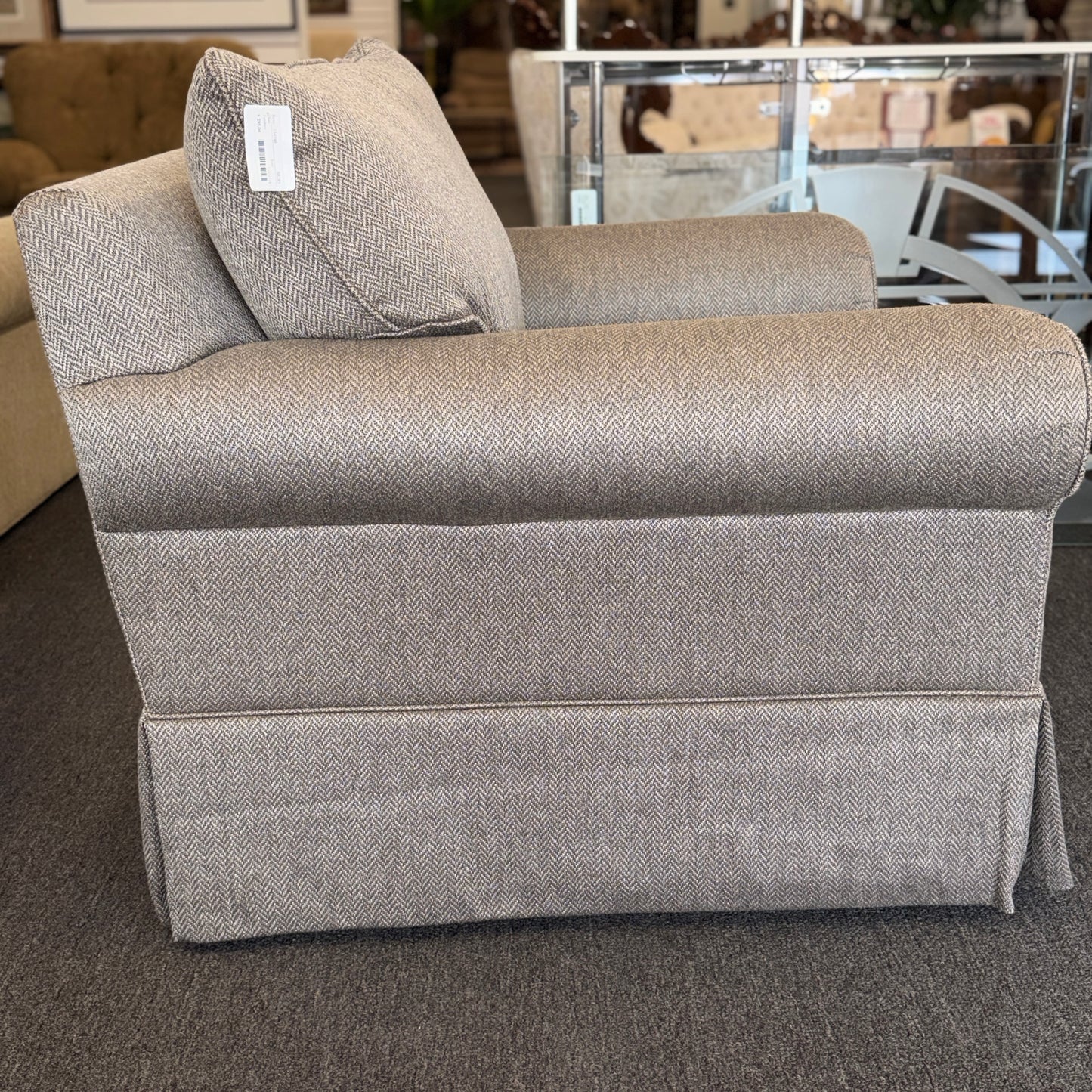 Gray upholstered chair with a patterned texture in an indoor setting