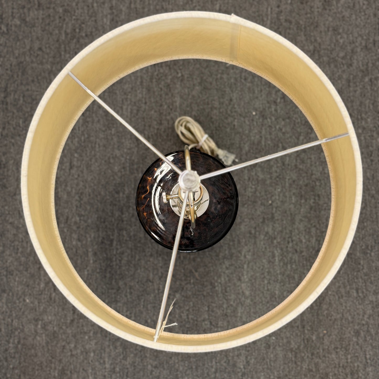 Wooden wheel with a central black component on a gray background