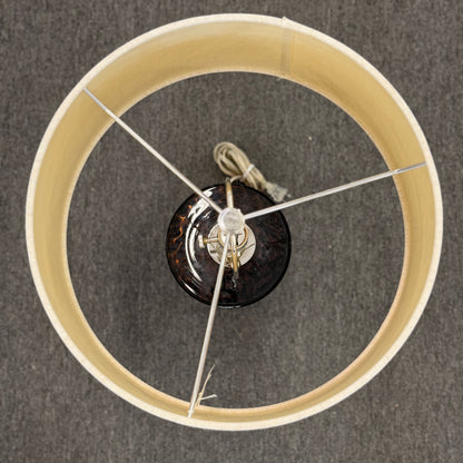 Wooden wheel with a central black component on a gray background