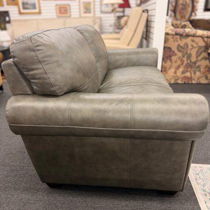 Gray leather armchair in a furniture store setting