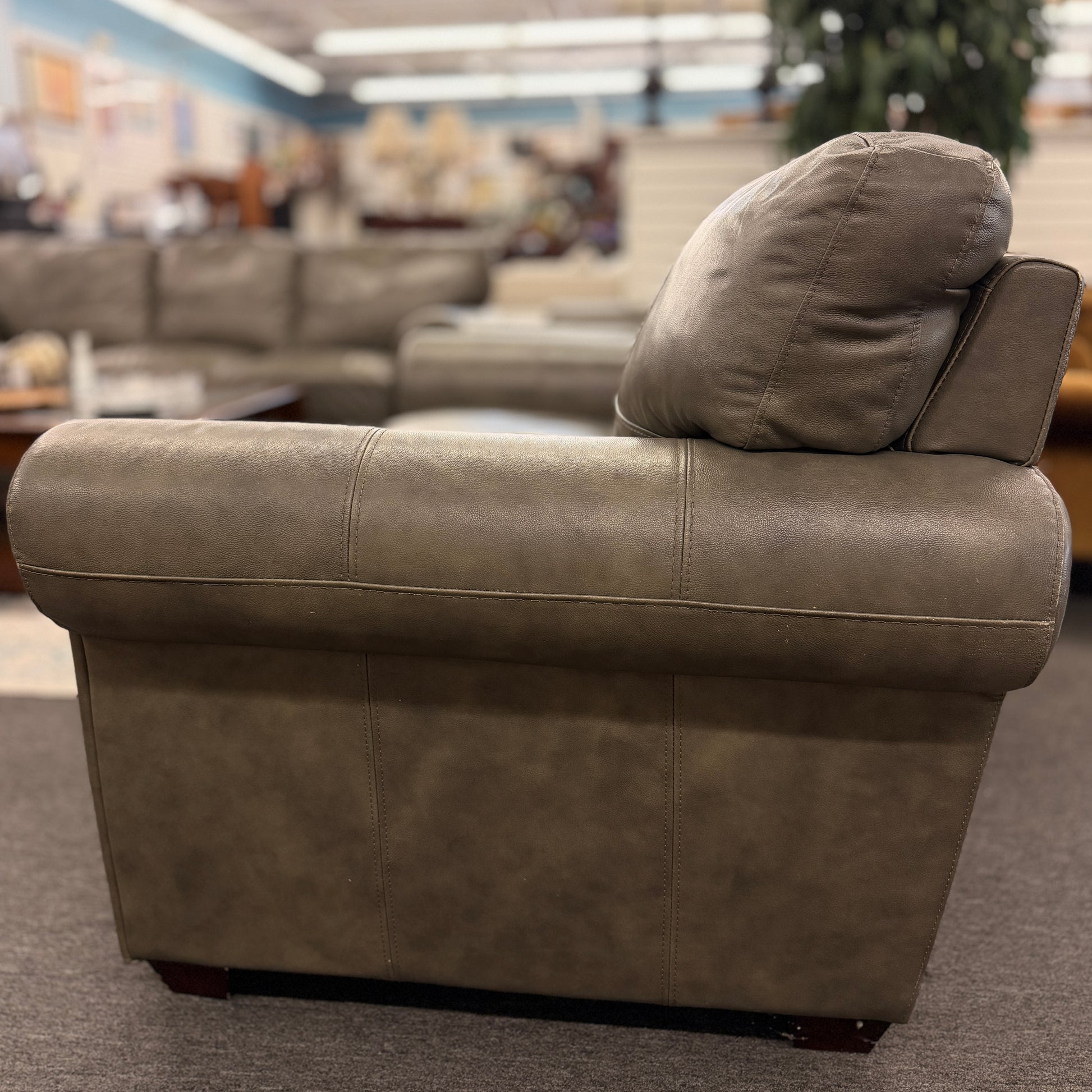 Brown leather sofa in a furniture store setting