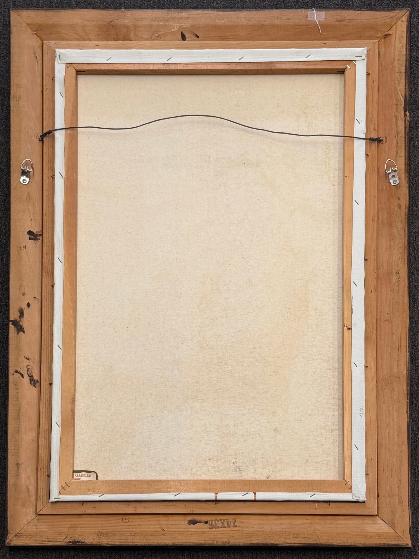 Back view of a wooden picture frame with a beige interior lining.
