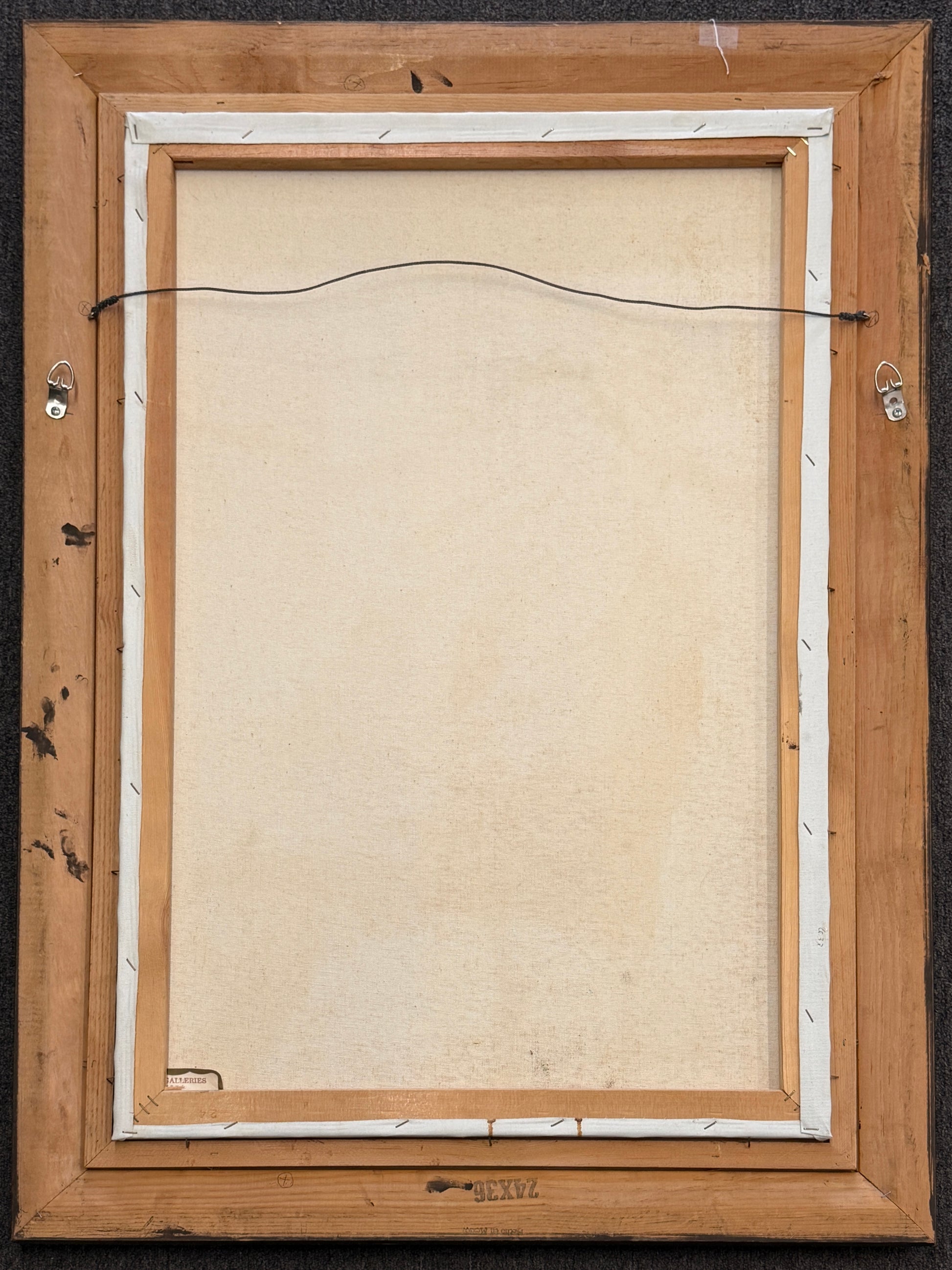 Back view of a wooden picture frame with a beige interior lining.