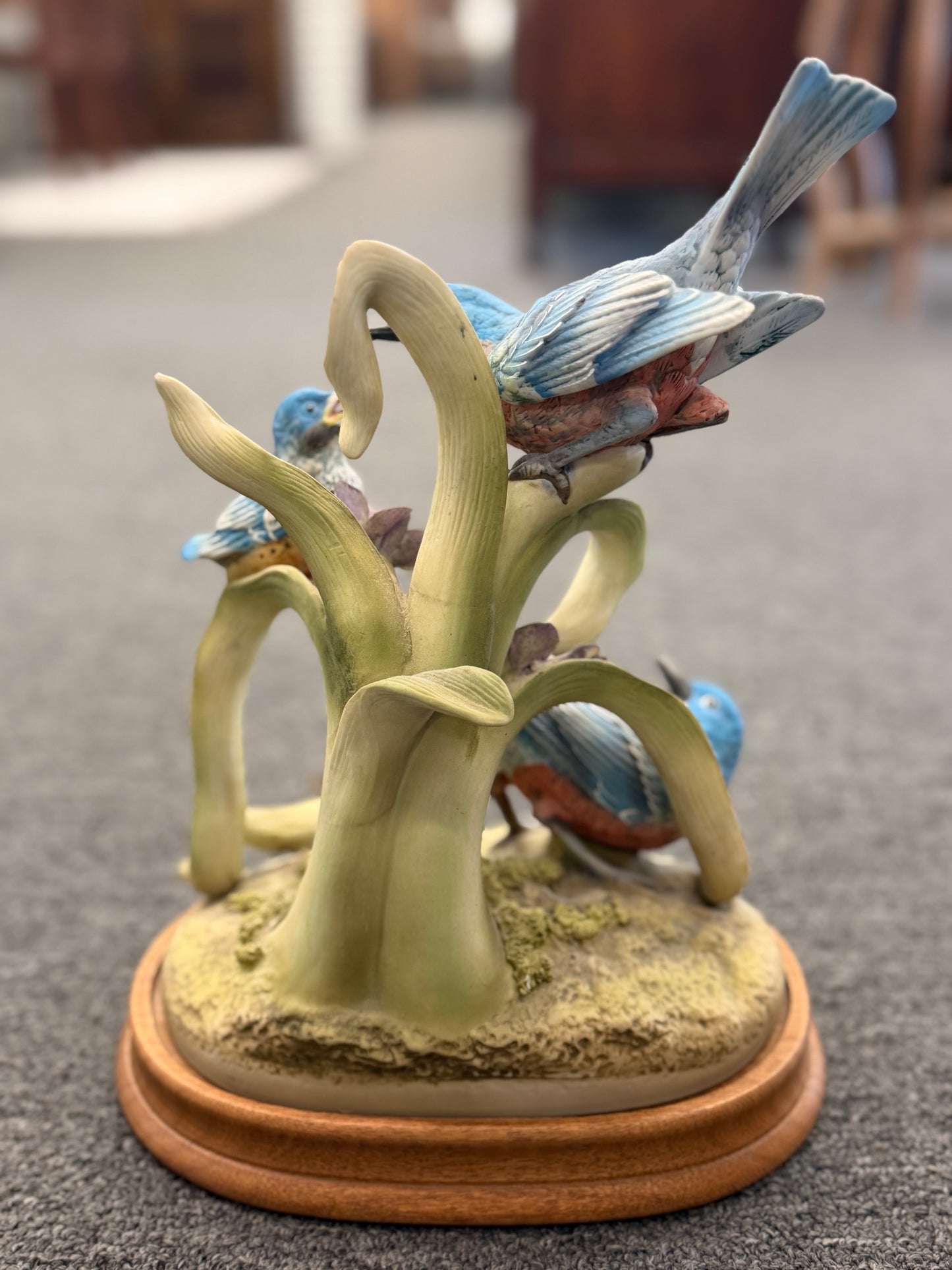 Decorative figurine of birds on a branch with a blurred background