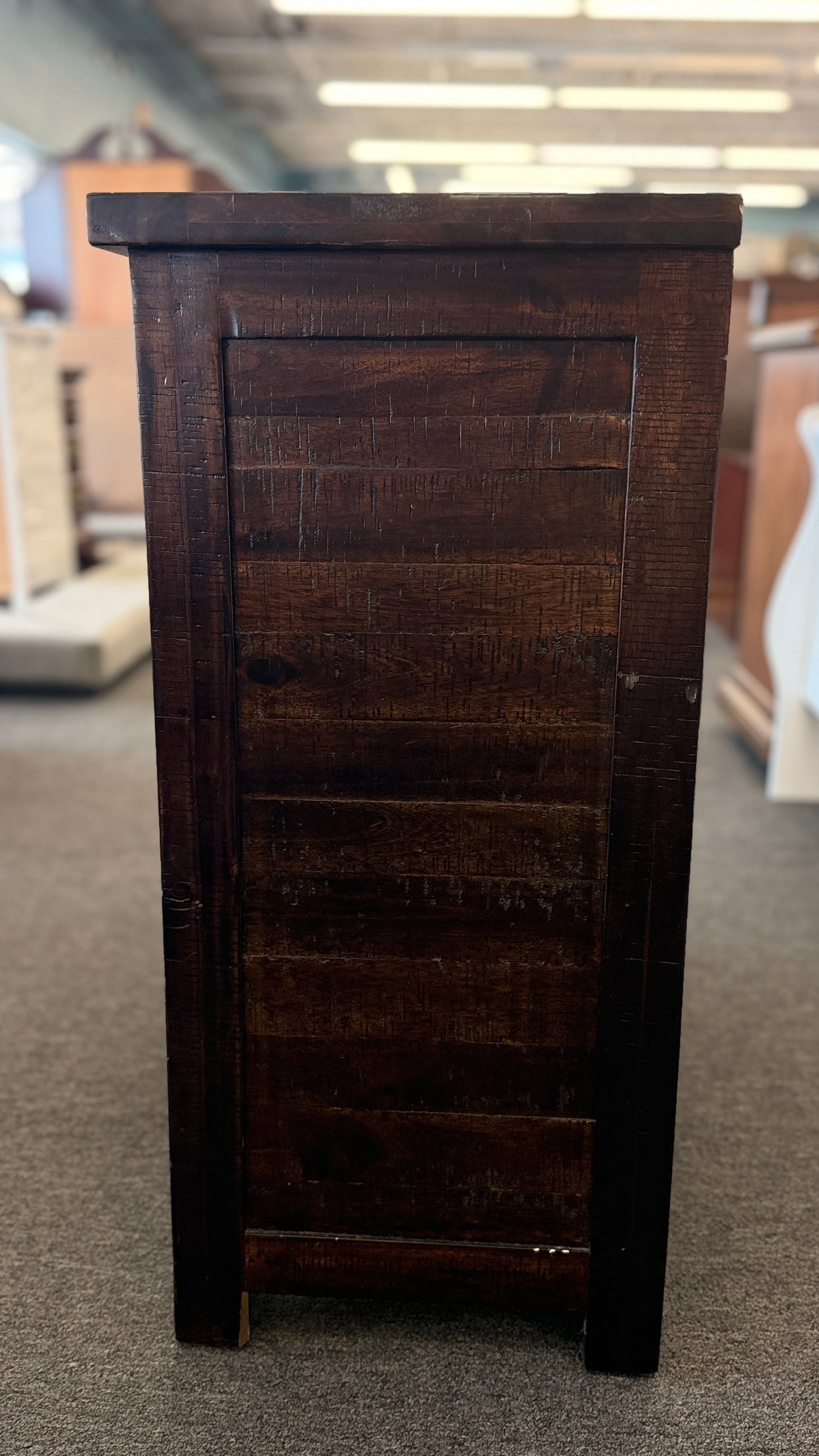 Dark wooden cabinet on a carpeted floor