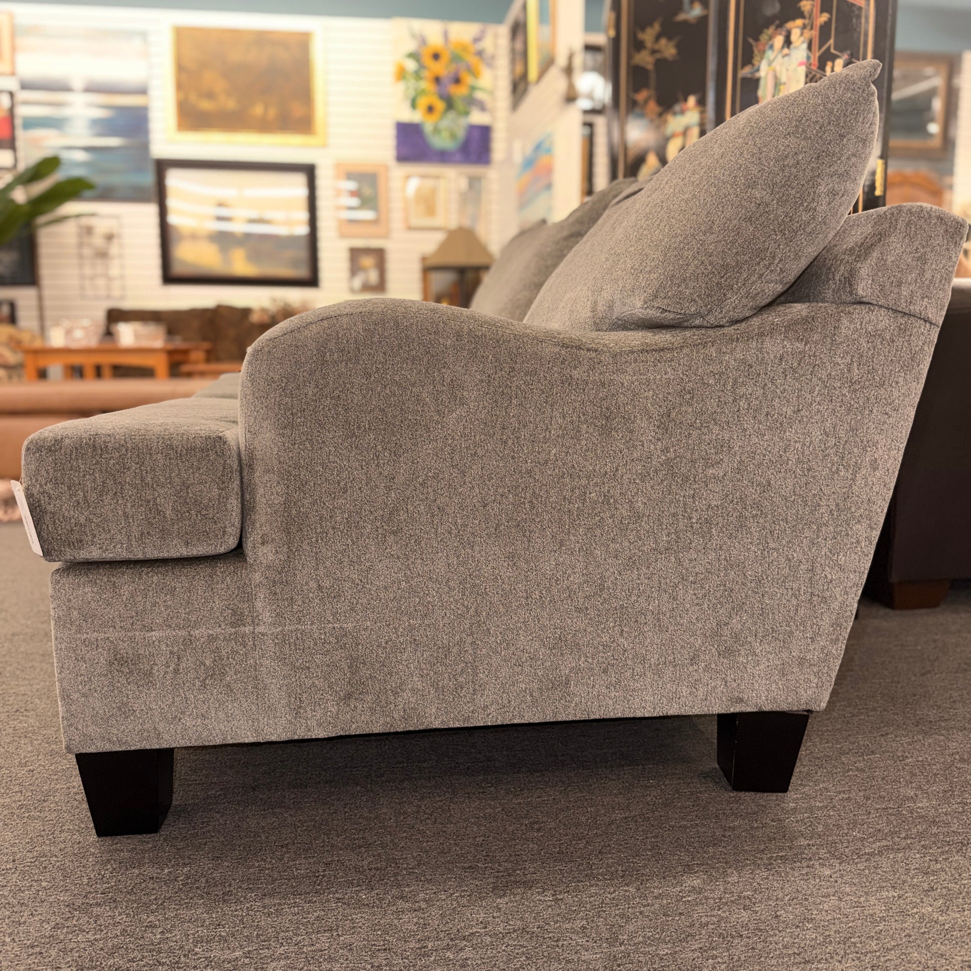 Gray upholstered chair in a room with decorative elements