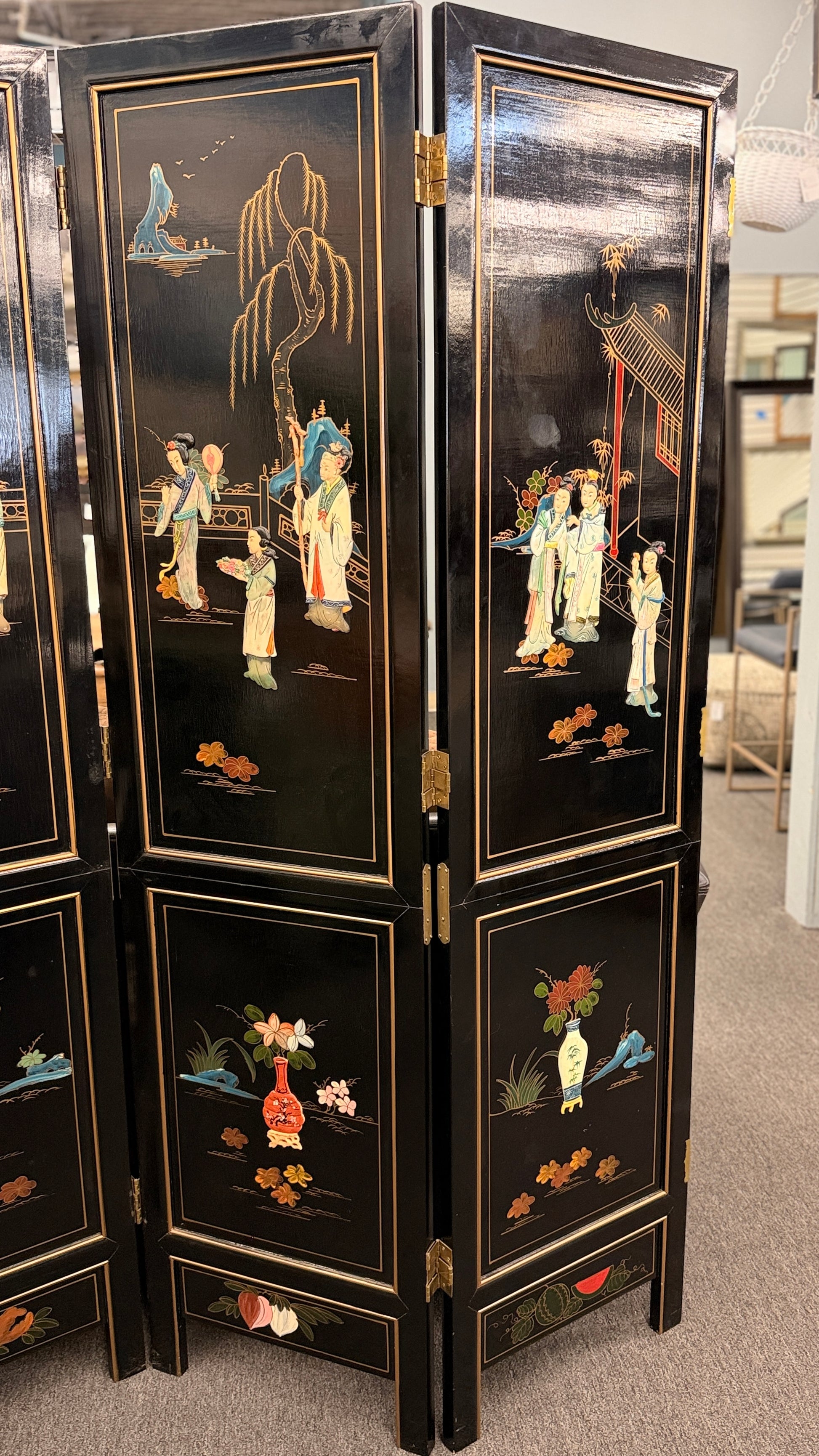 Traditional Chinoiserie multi panel wood folding room divider and privacy screen featuring intricate decorative designs on a carpeted floor at 2nd Debut Houston consignment showroom