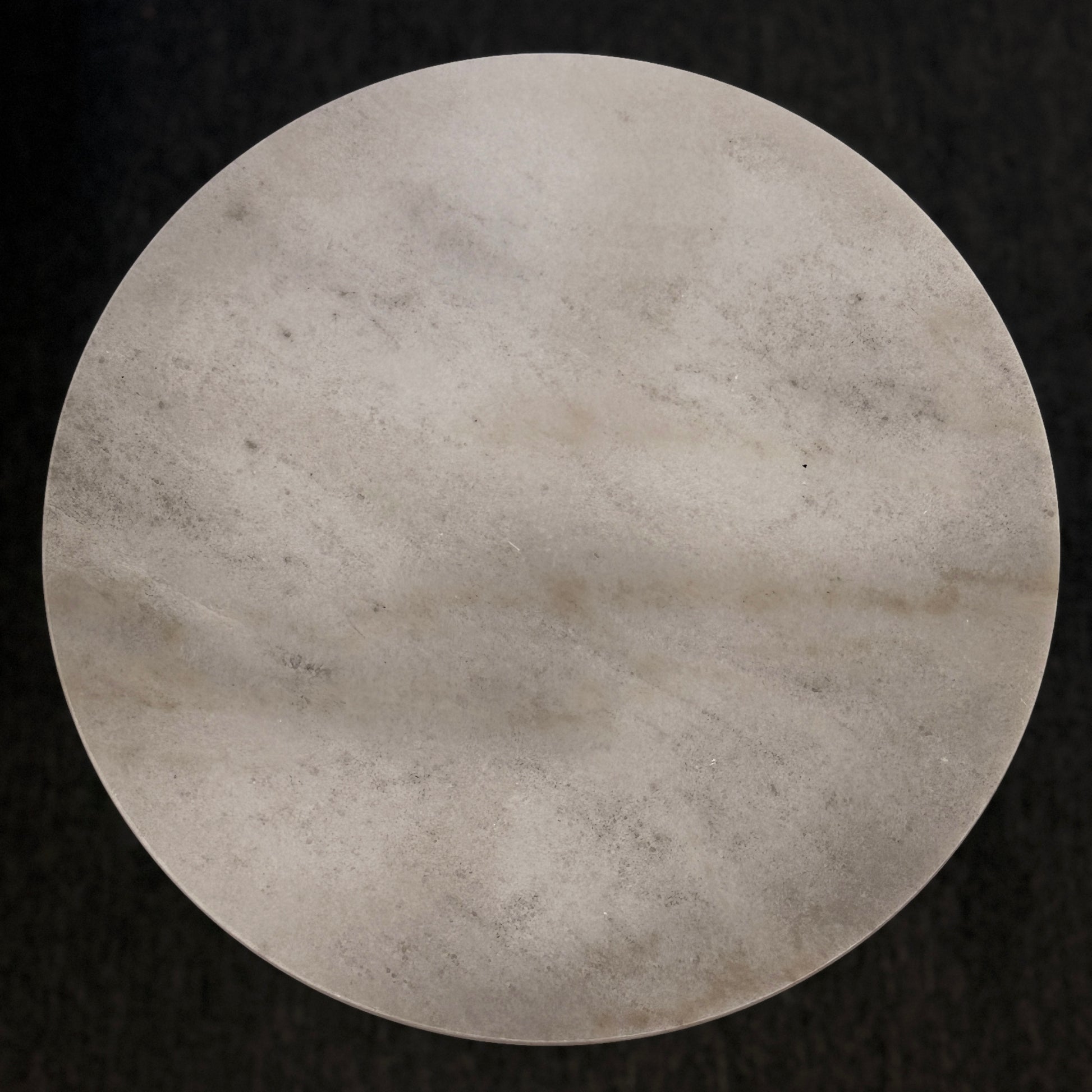 Round stone surface on a black background