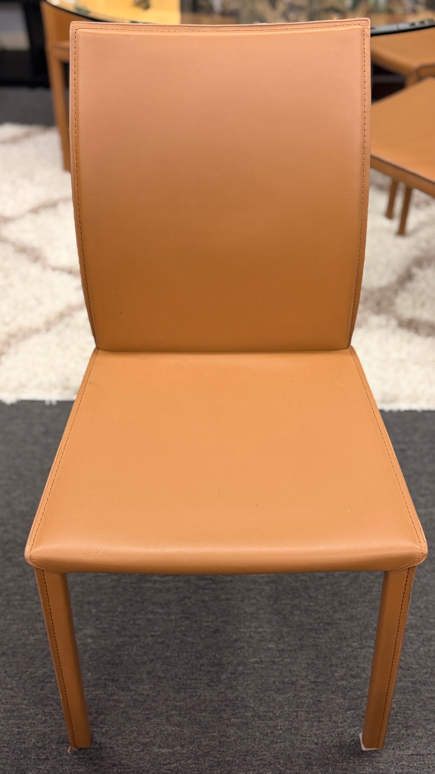 Tan chair on a carpeted floor