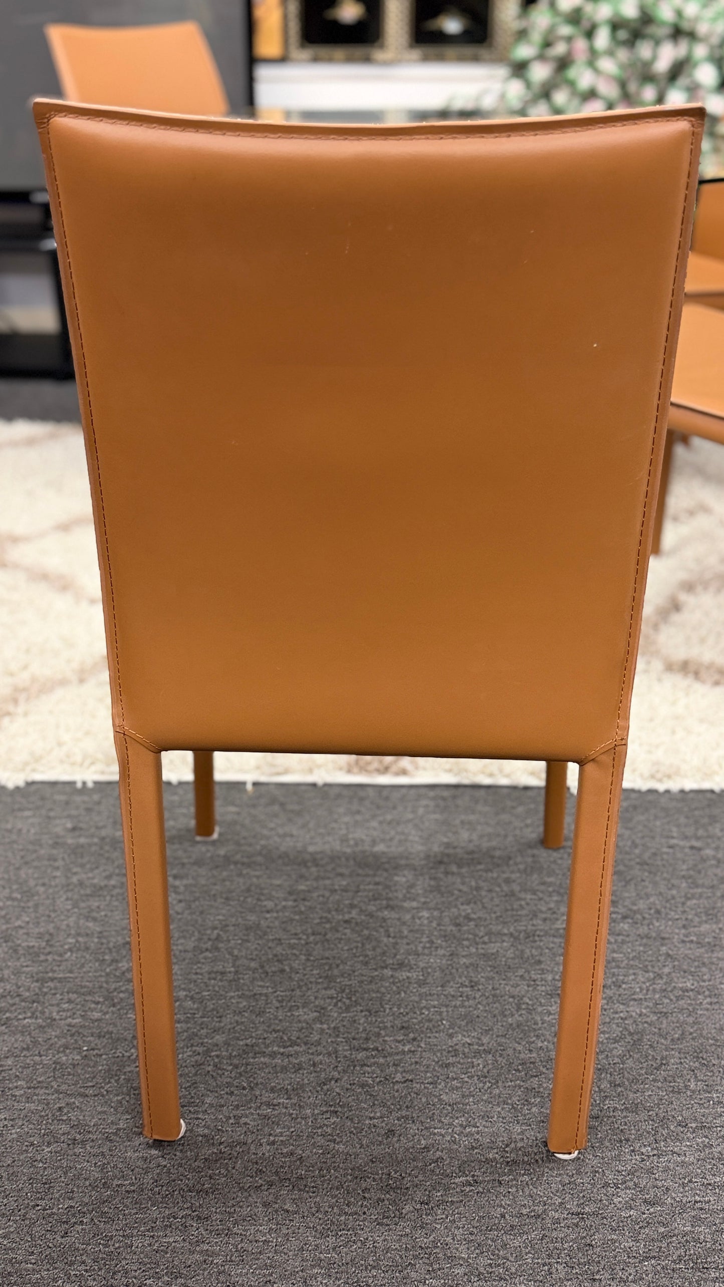 Brown chair backrest on a gray floor with a blurred background