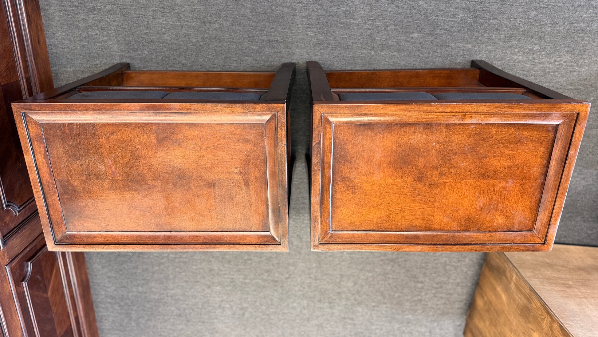 Two wooden drawers on a textured gray surface