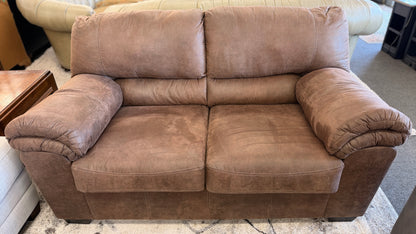 Brown leather sectional sofa in a showroom setting
