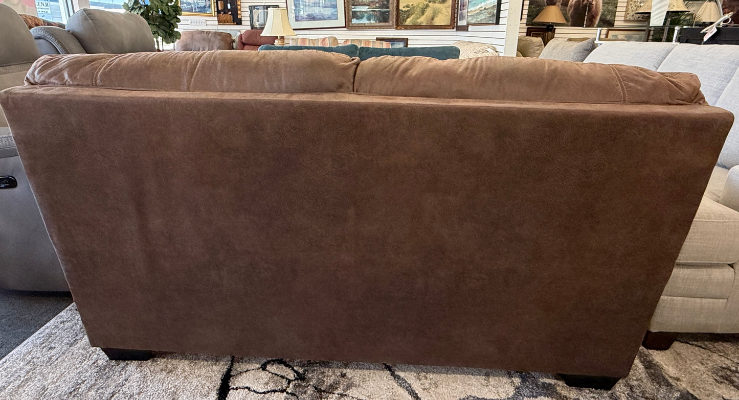 Brown leather sectional sofa in a showroom setting