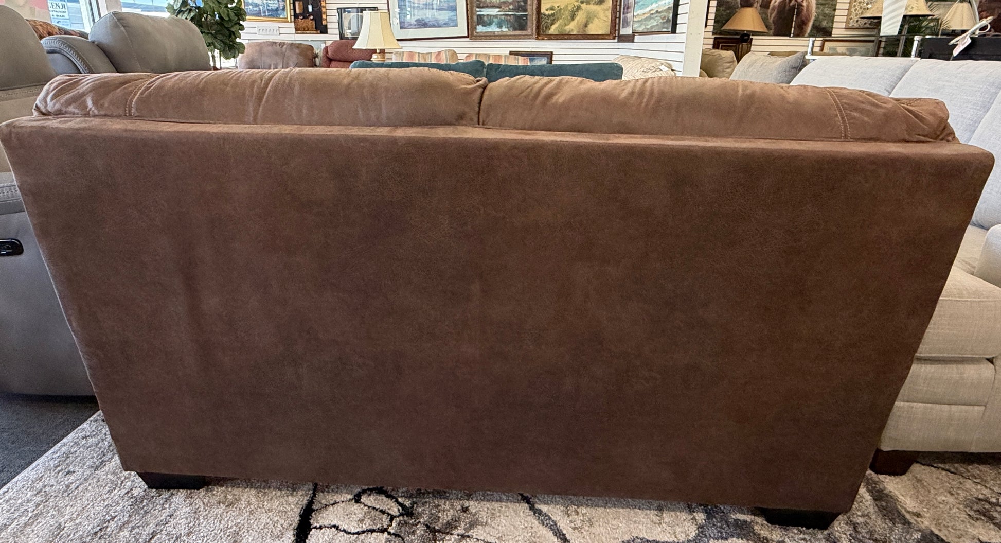Brown leather sectional sofa in a showroom setting
