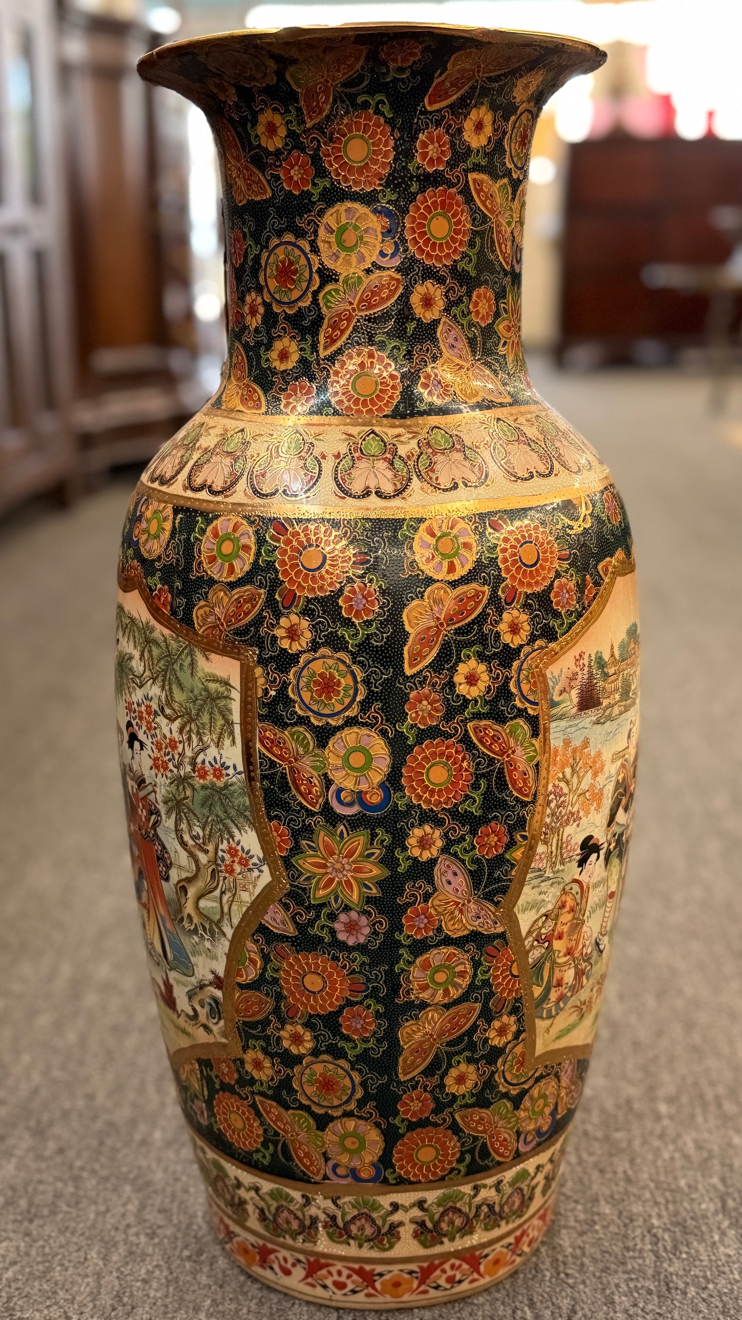 Decorative vase with intricate patterns on a carpeted floor