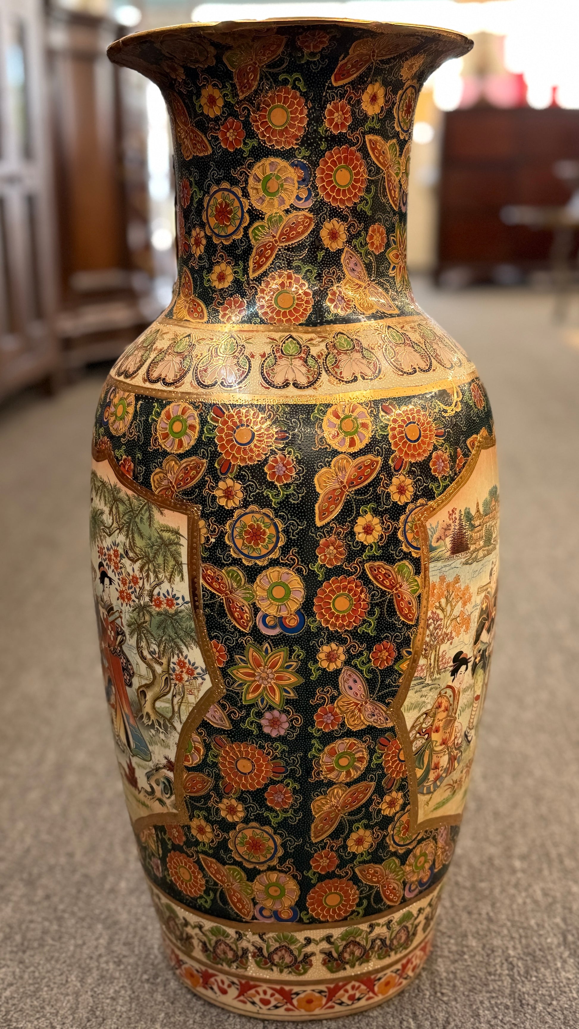 Decorative vase with intricate patterns on a carpeted floor