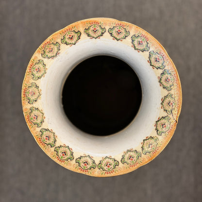 Decorative ceramic vase with a patterned rim on a dark background