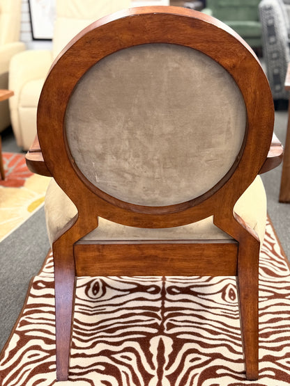 Wooden chair with a round backrest and zebra print seat cover.