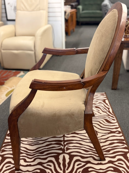Chair with wooden armrests on a zebra print rug in a room setting