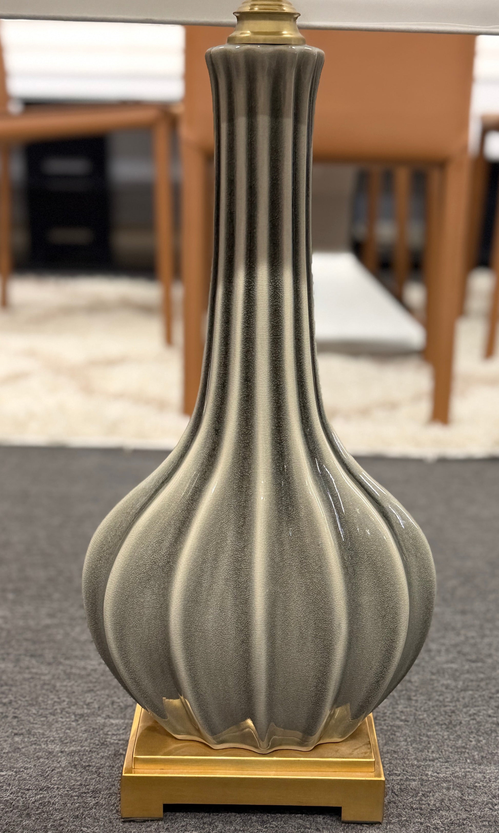 Decorative vase with ribbed design on a textured surface