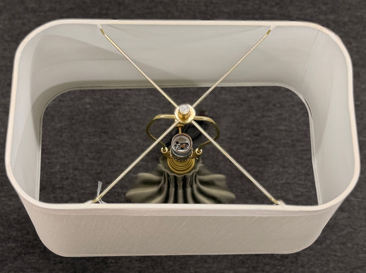 Modern wall clock with white frame and gold accents on a dark background