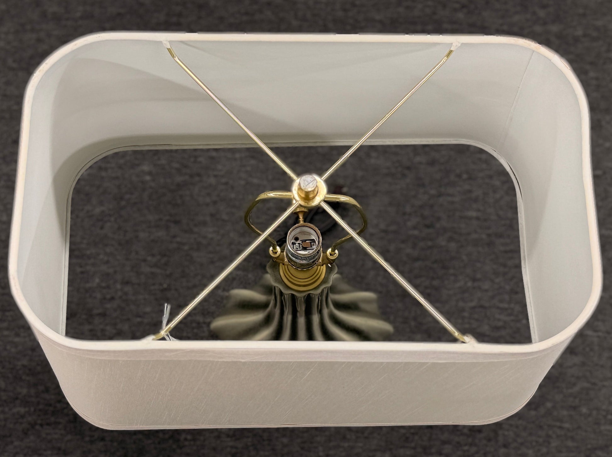 Modern wall clock with white frame and gold accents on a dark background