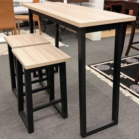 High table with two matching stools in a room setting