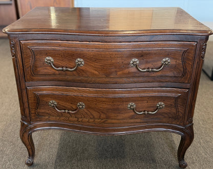 Wooden dresser with two drawers on a carpeted floor