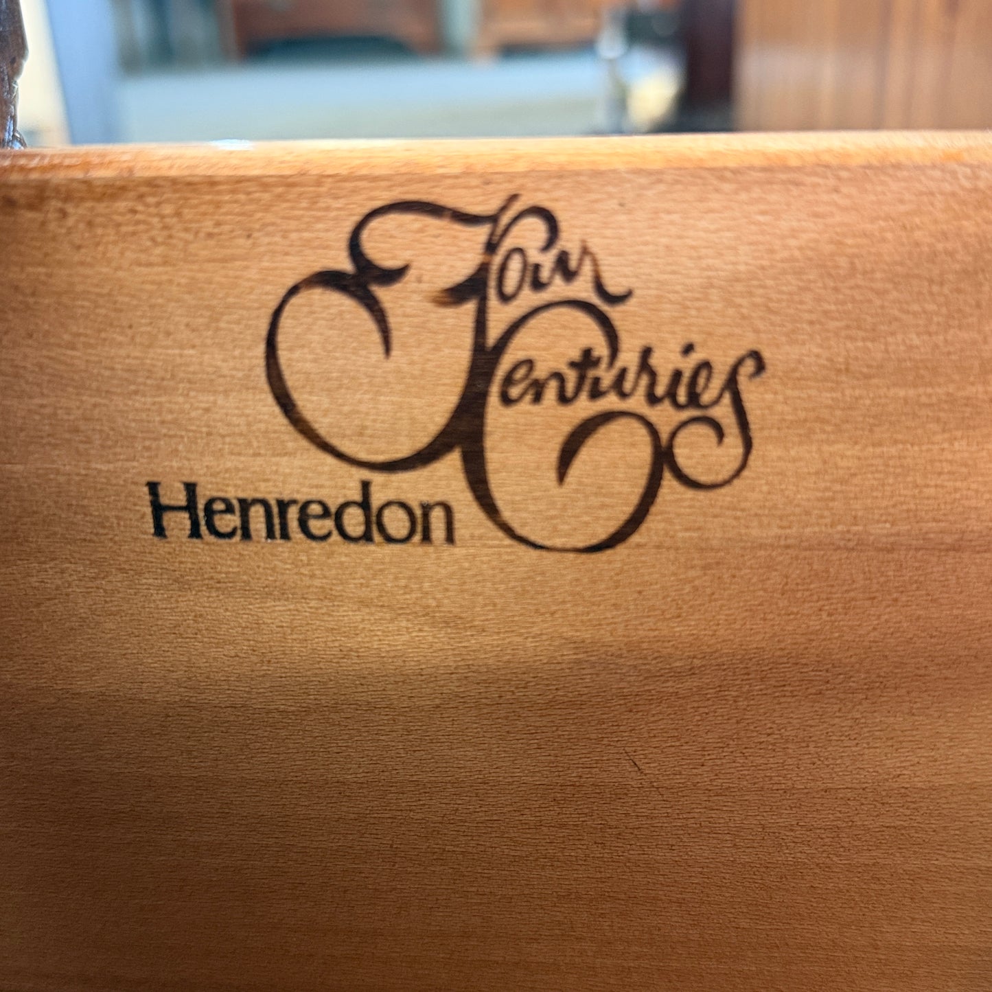 Wooden surface with 'Four Centuries Henredon' engraving