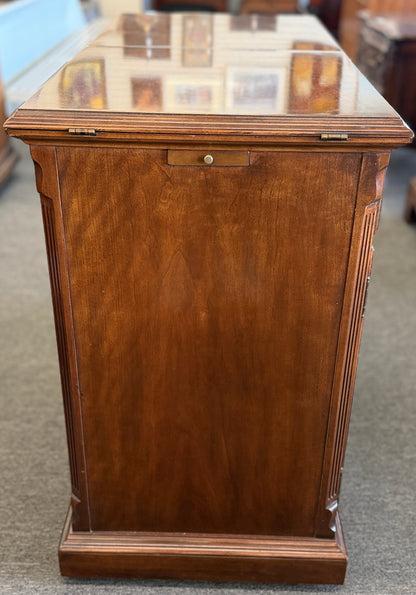 Wooden display case with glass top on a carpeted floor