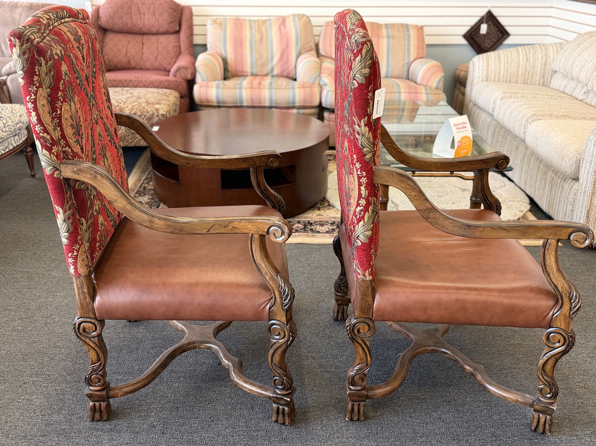Traditional Gothic carved wood and red tapestry 2pc armchairs with brown leather seats at 2nd Debut Houston consignment showroom
