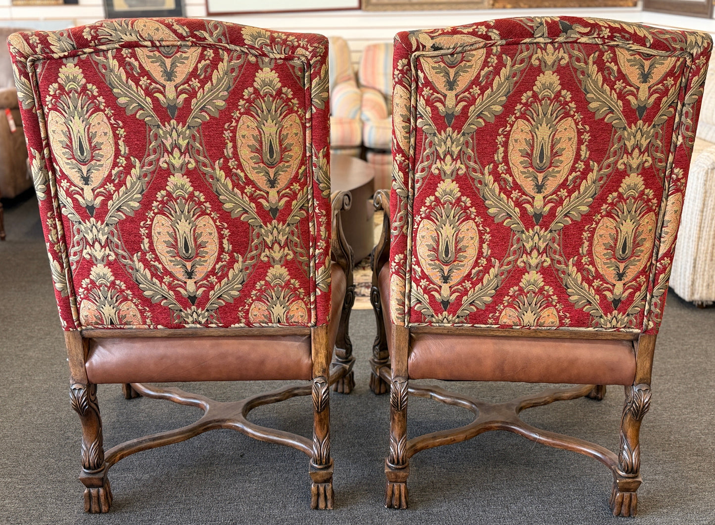 Traditional Gothic carved wood and red tapestry 2pc armchairs with brown leather seats at 2nd Debut Houston consignment showroom