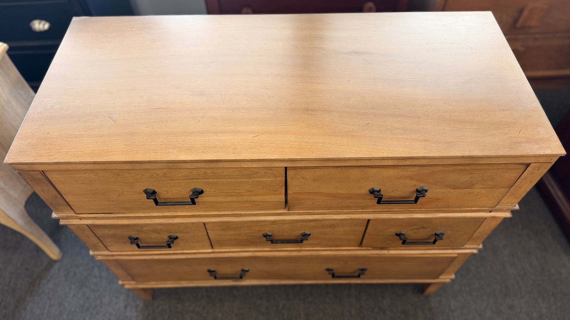 Traditional golden brown wood 6 drawer dresser featuring a unique multi tier layout and drop handles at 2nd Debut Houston consignment showroom