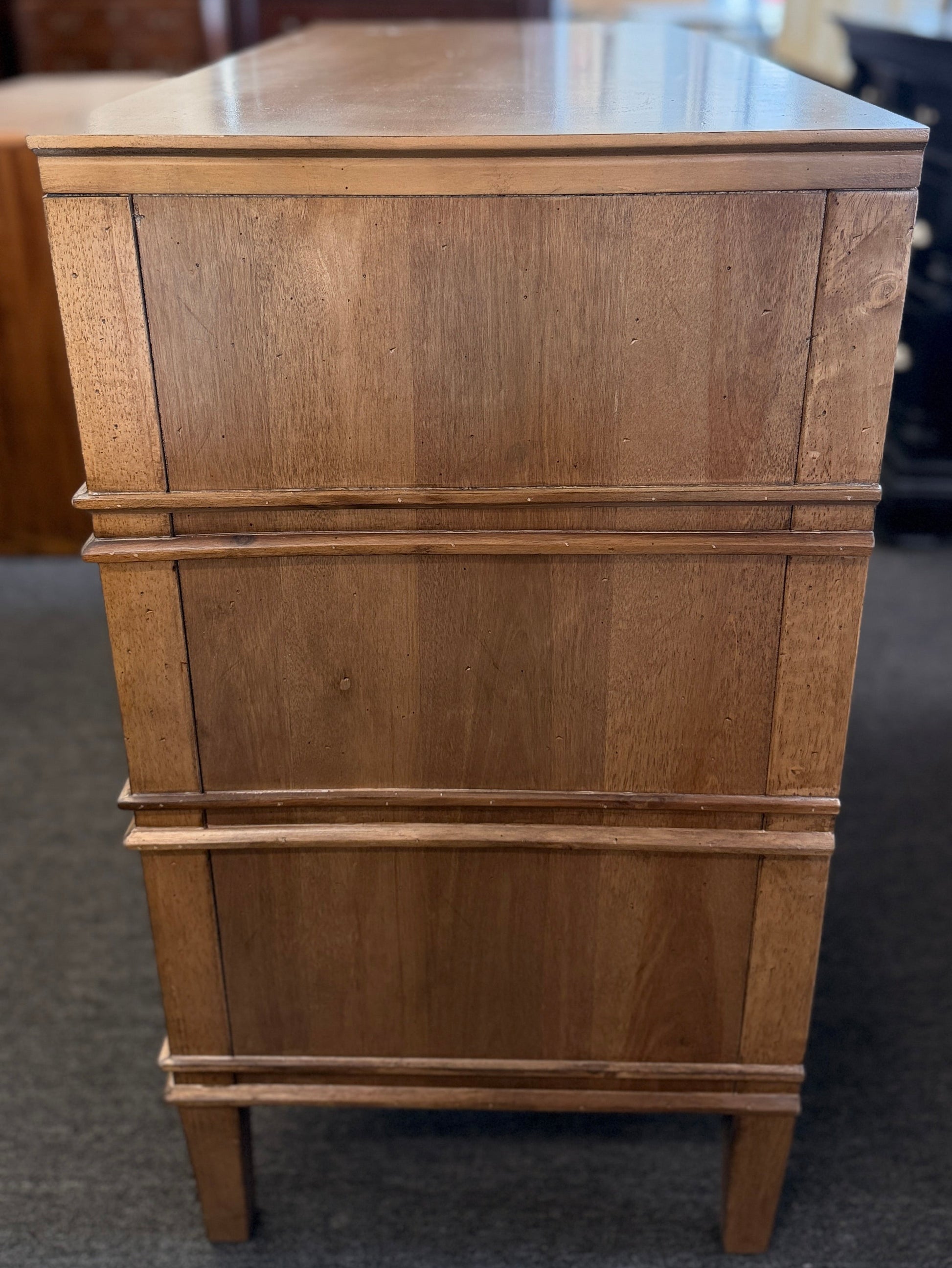Traditional golden brown wood 6 drawer dresser featuring a unique multi tier layout and drop handles at 2nd Debut Houston consignment showroom