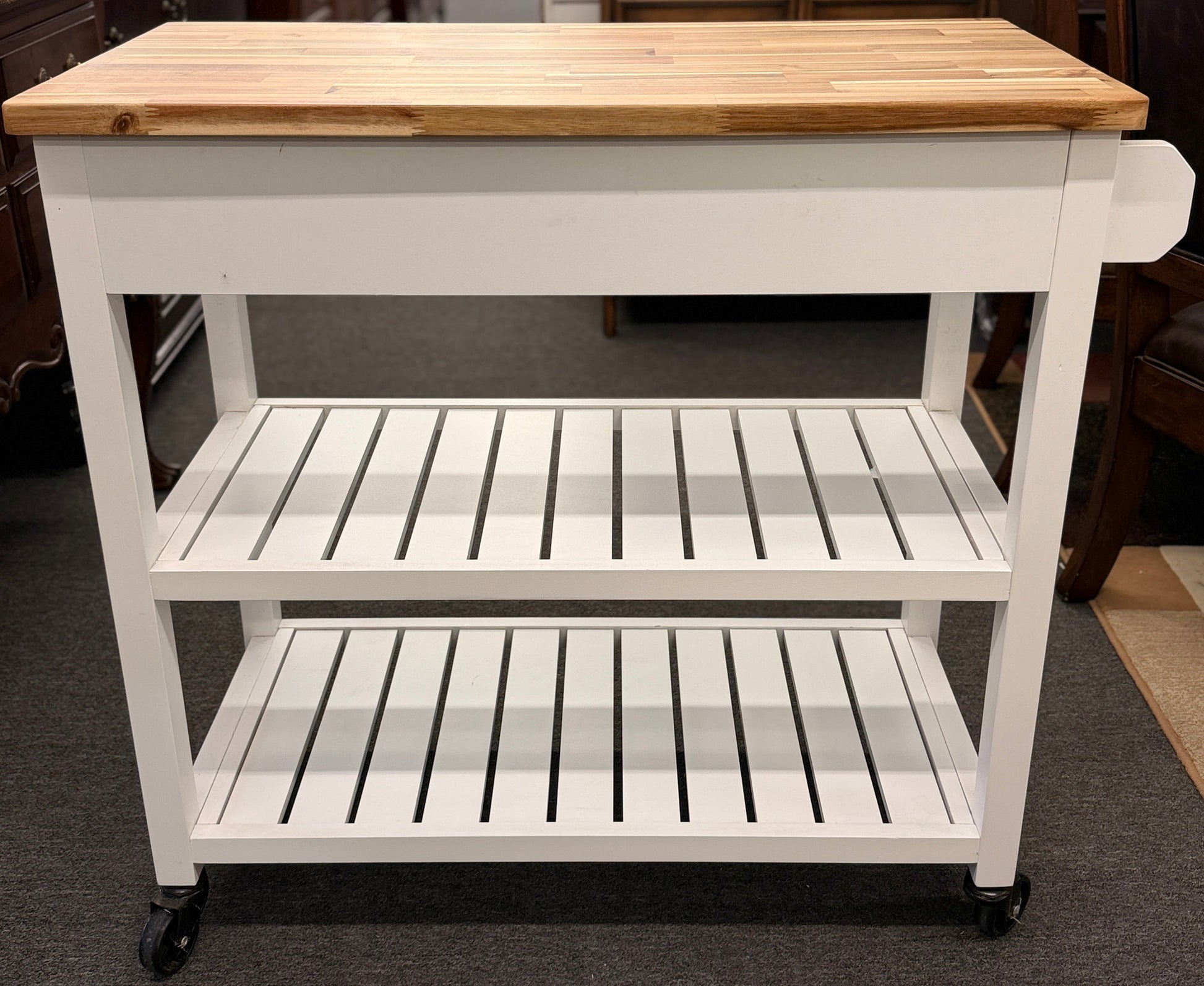 White kitchen cart with wooden top in a room setting