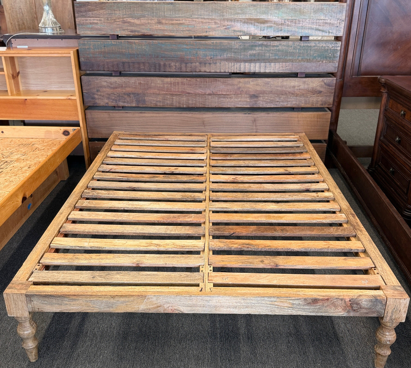Wooden bed frame in a furniture store setting