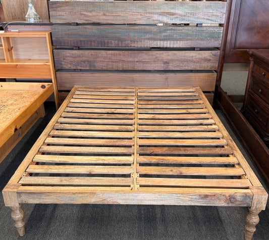 Wooden bed frame in a furniture store setting