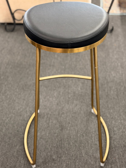 Modern geometric brass and black leather barstool set featuring slender metal legs and a half circle footrest at 2nd Debut Houston consignment showroom