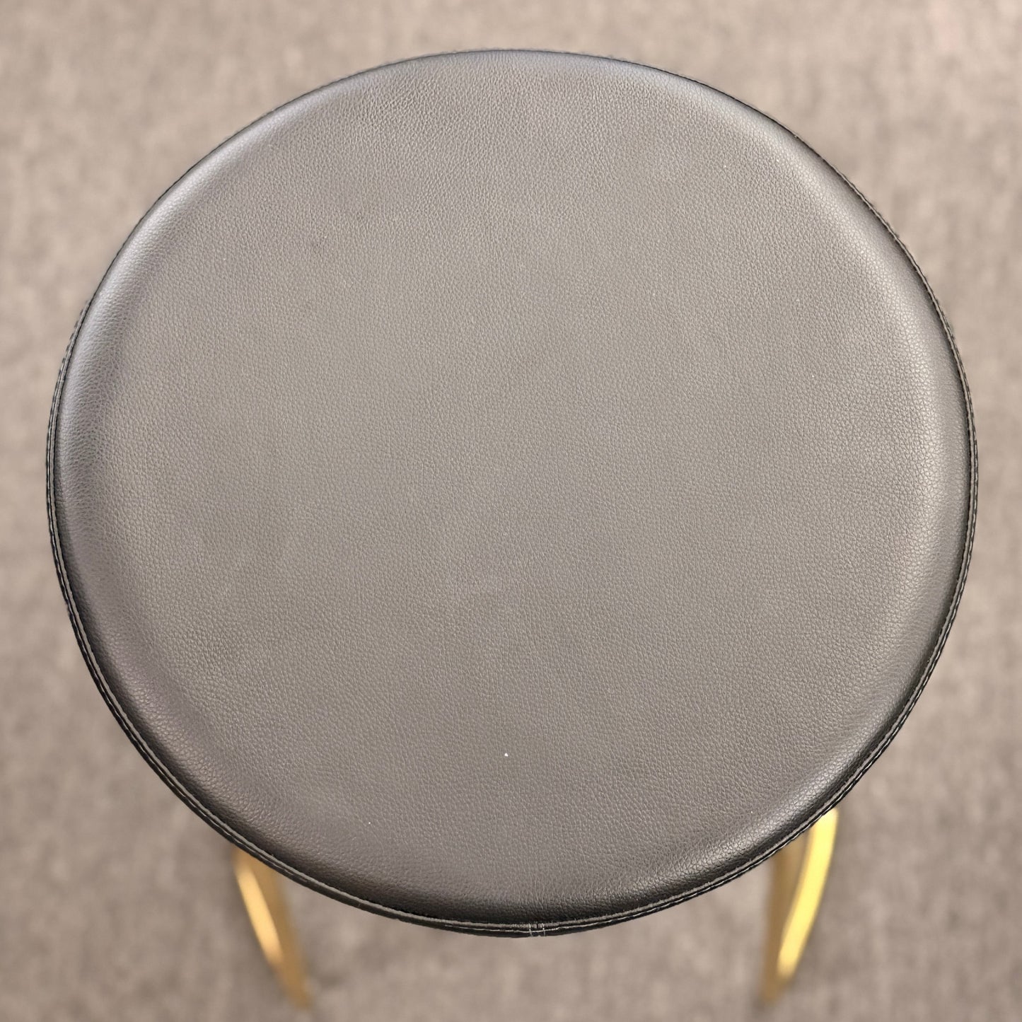 Modern geometric brass and black leather barstool set featuring slender metal legs and a half circle footrest at 2nd Debut Houston consignment showroom