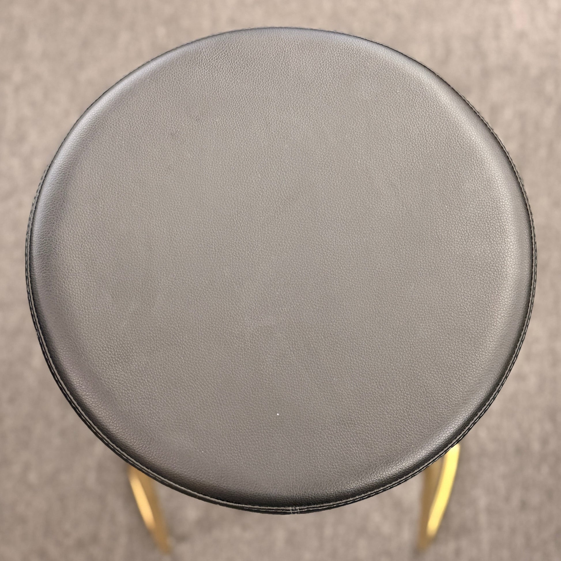 Modern geometric brass and black leather barstool set featuring slender metal legs and a half circle footrest at 2nd Debut Houston consignment showroom