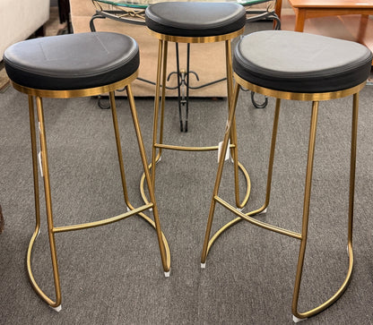 Modern geometric brass and black leather barstool set featuring slender metal legs and a half circle footrest at 2nd Debut Houston consignment showroom