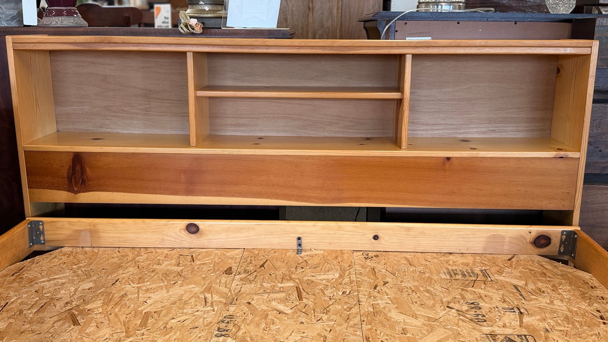 Wooden bed with storage compartments and a wooden floor.