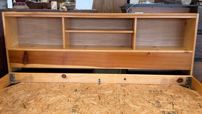 Wooden bed with storage compartments and a wooden floor.