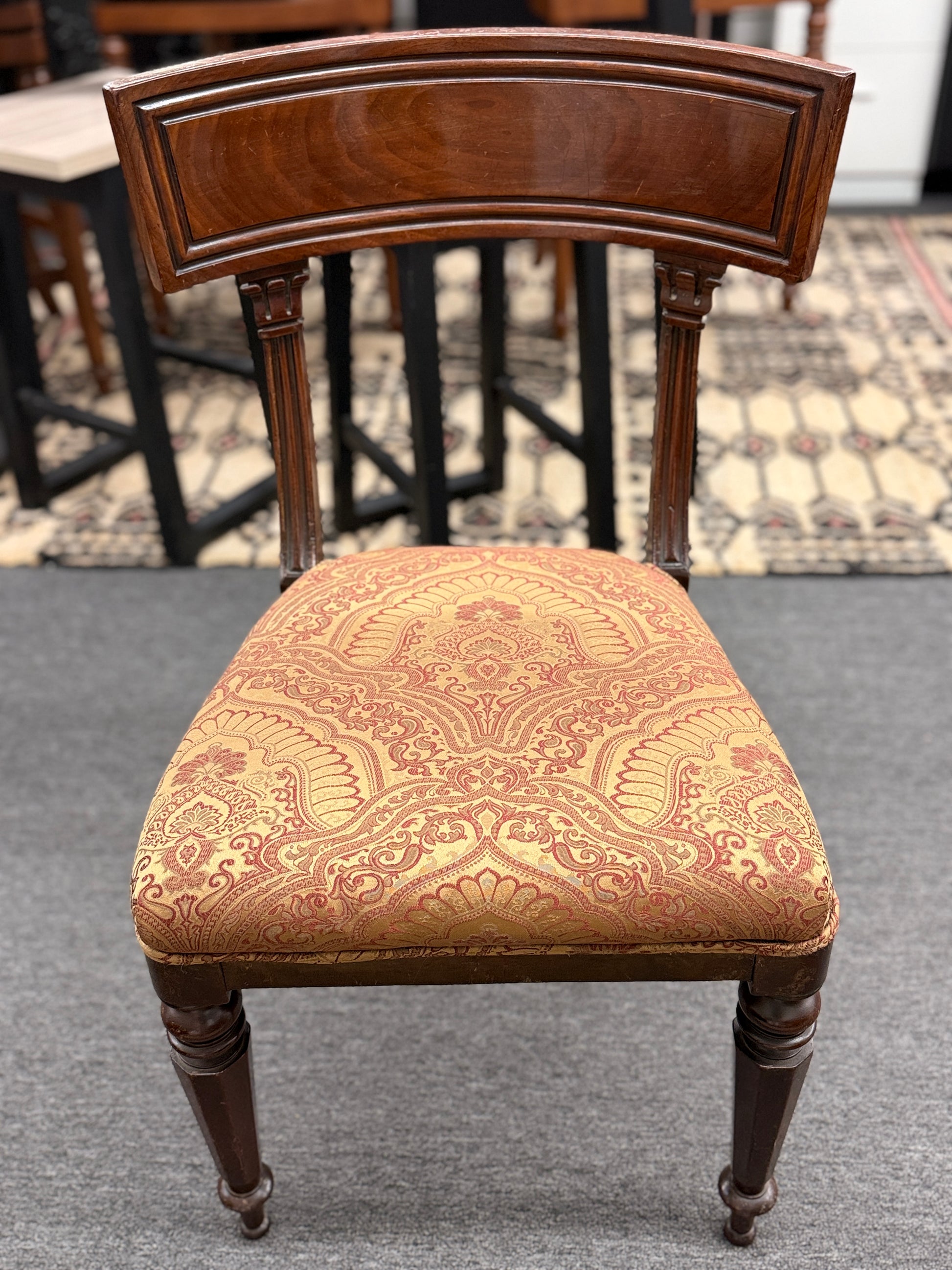 Traditional dark wood round pedestal dining set with 51 inch table and patterned fabric chairs at 2nd Debut Houston consignment showroom