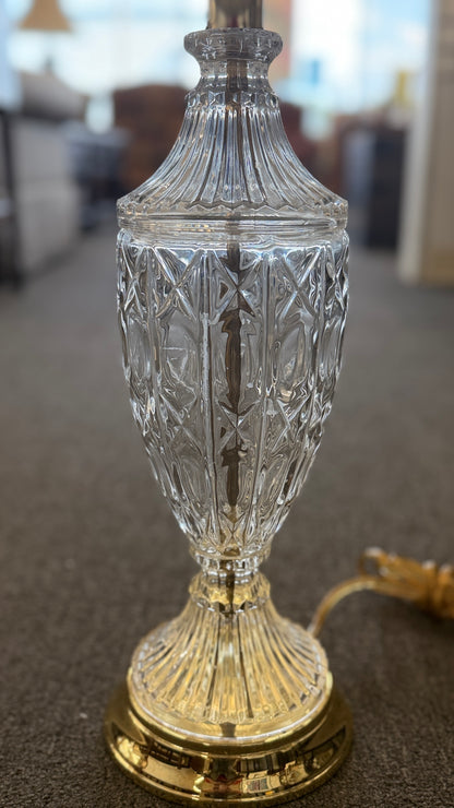 A traditional 29-inch table lamp featuring a diamond-cut crystal urn-shaped body, a polished gold base, and a classic white flared fabric lampshade.